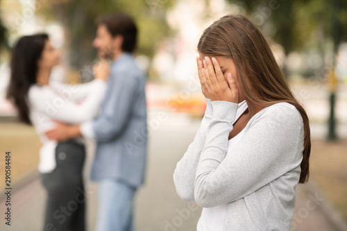 Fototapeta Upset woman crying, seeing her boyfriend with other girl