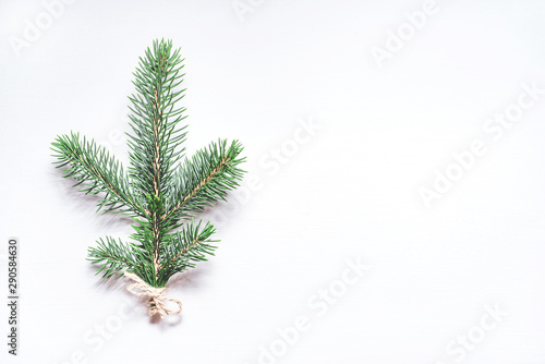 Christmas composition with a sprig of fir on a white background. Flat lay, top view.