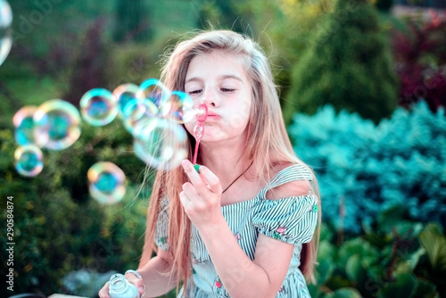 beautiful little girl child. Outdoors  blowing bubbles. Children s lifestyle