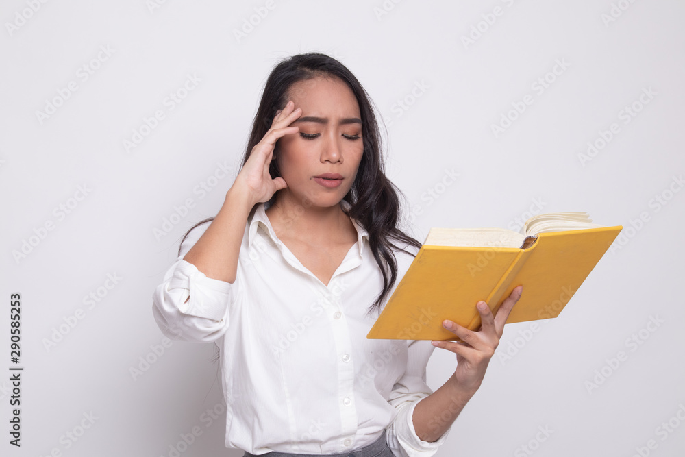 Young Asian woman got headache read a book.