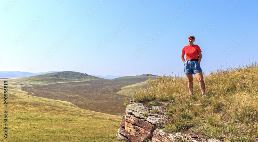 Woman hiker on the top of mountain