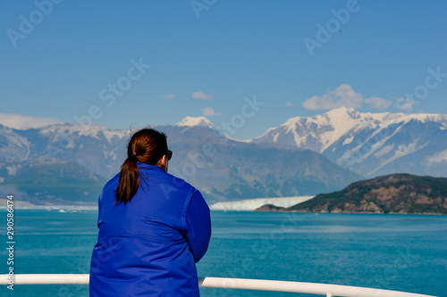 Woman looking out at a Glacier in the distance. 