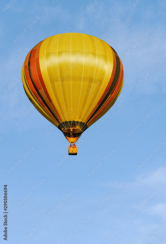 Naklejka premium Colorful hot air balloon in the blue sky with clouds.