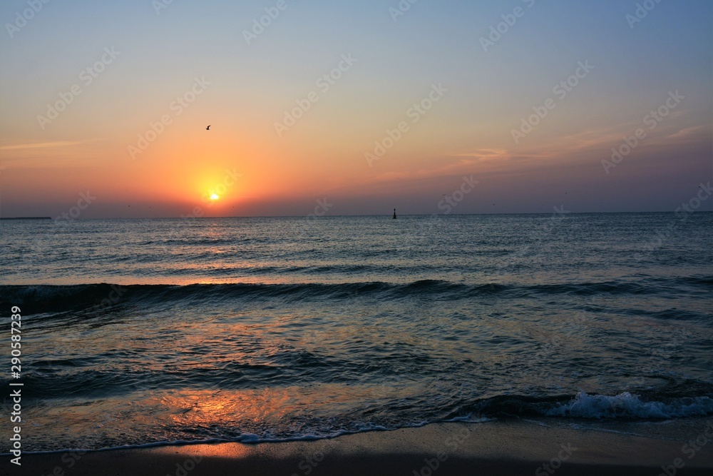 a beautiful sunrise at the seashore a beautiful sunrise at the seashore