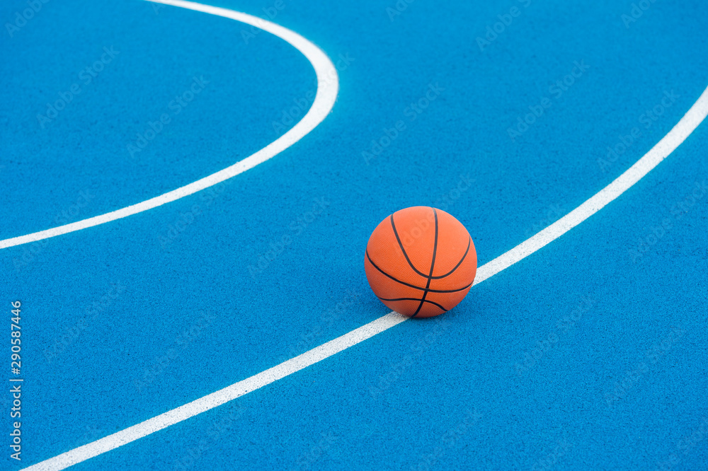 Orange Basketball ball on the blue surface Orange Basketball ball on the blue surface