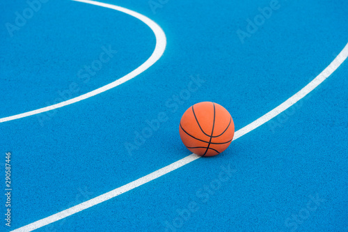 Orange Basketball ball on the blue surface © Augustas Cetkauskas
