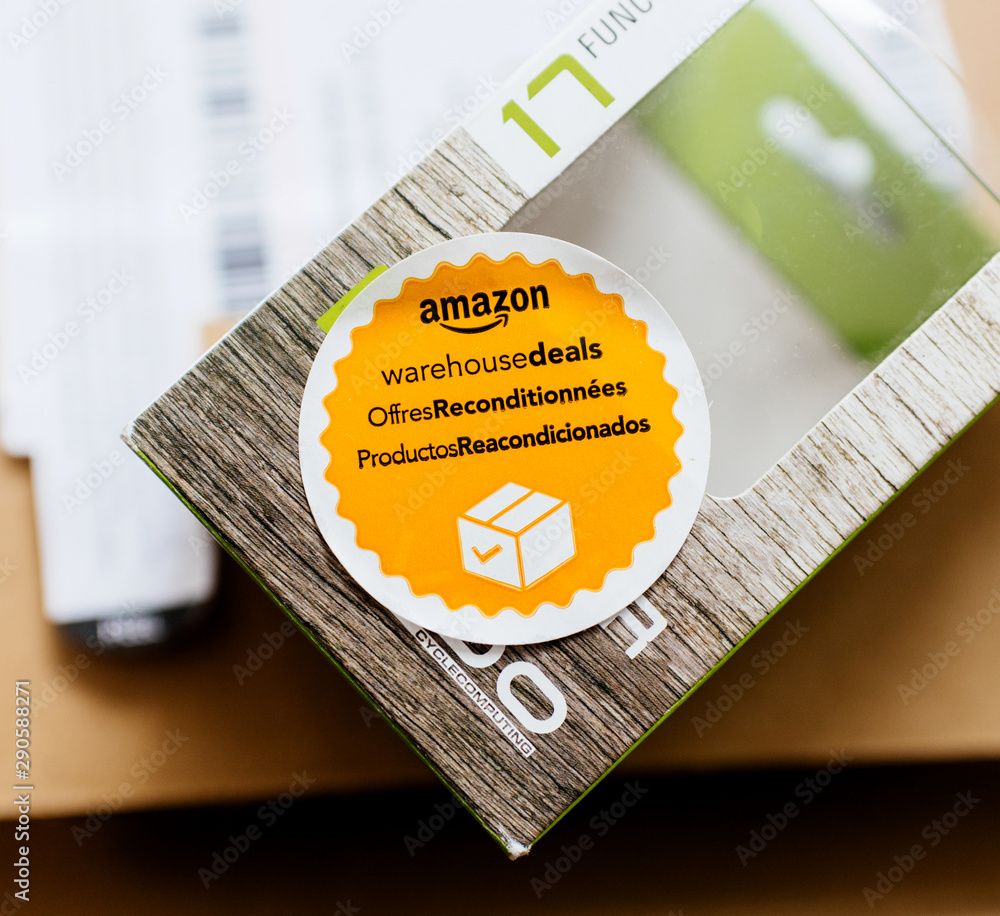 PARIS FRANCE APR 24 2018 Amazon Warehouse Deals offres reconditionnees productos reacondicionados sticker on new object bought online from the biggest online retailer Stock Foto Adobe Stock