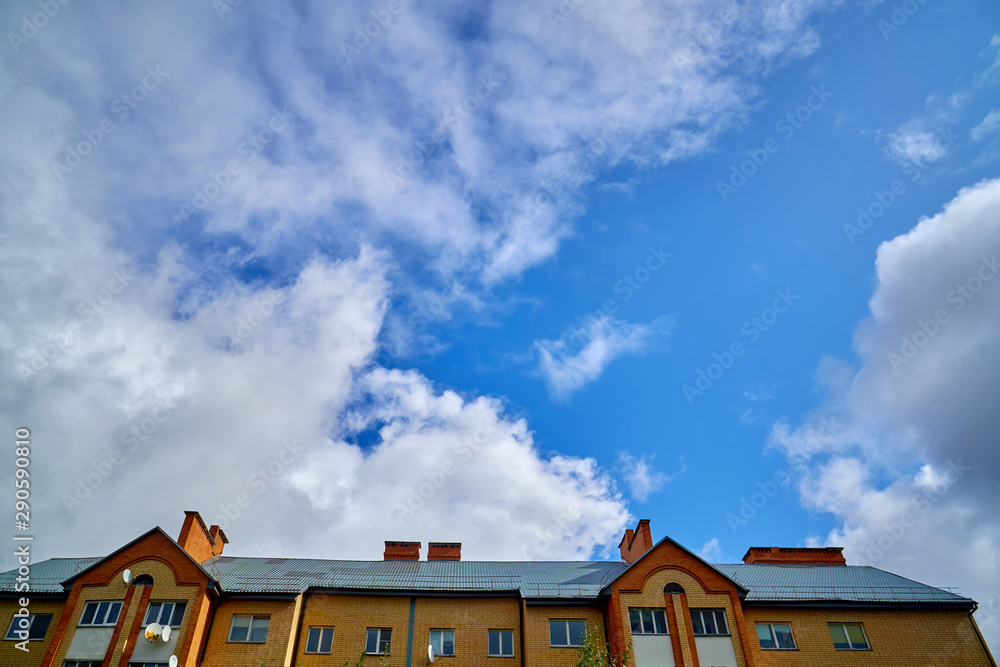 House roof and blue sky with clouds. House roof and blue sky with clouds.
