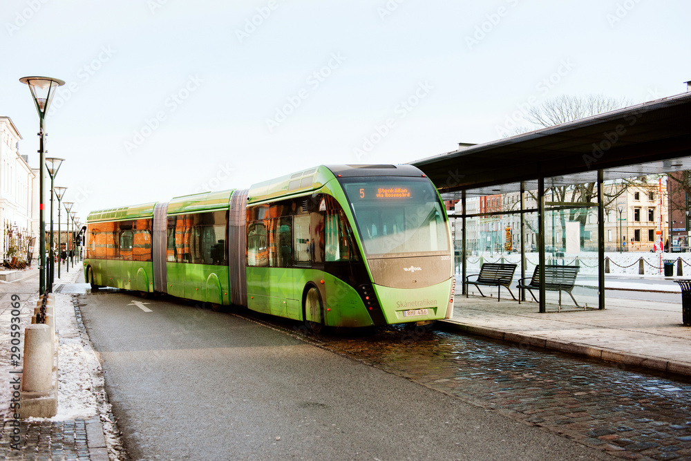 MALMO, SWEDEN - 29 DEC 2014: Green articulated bus Van Hool 324H Exequicity  24 Hybrid operated by Skanetrafiken arriving in bus station on a cold  winter day - transportation line 5 in Malmo Stock Photo | Adobe Stock