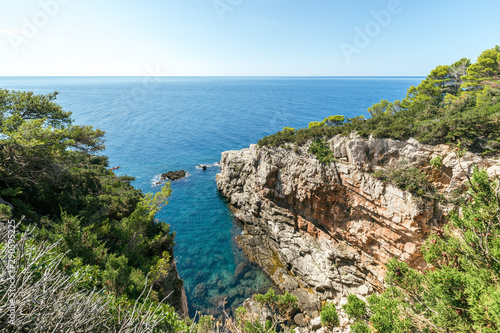 Views of the Adriatic Sea - clear blue water  boat  rocky shore. Sea cruise in a paradise