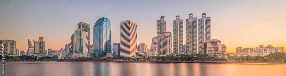 Skyscrapers Reflected in a Lake at Sunrise. Benjakiti Park in Bangkok, Thailand