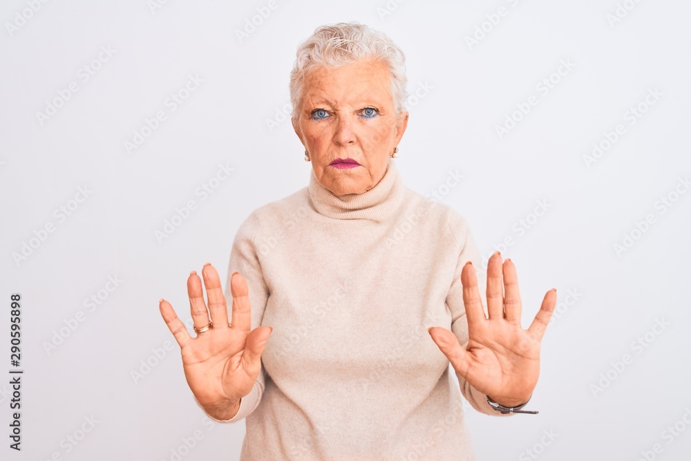 Senior grey-haired woman wearing turtleneck sweater standing over isolated white background Moving away hands palms showing refusal and denial with afraid and disgusting expression Senior grey-haired woman wearing turtleneck sweater standing over isolated white background Moving away hands palms showing refusal and denial with afraid and disgusting expression