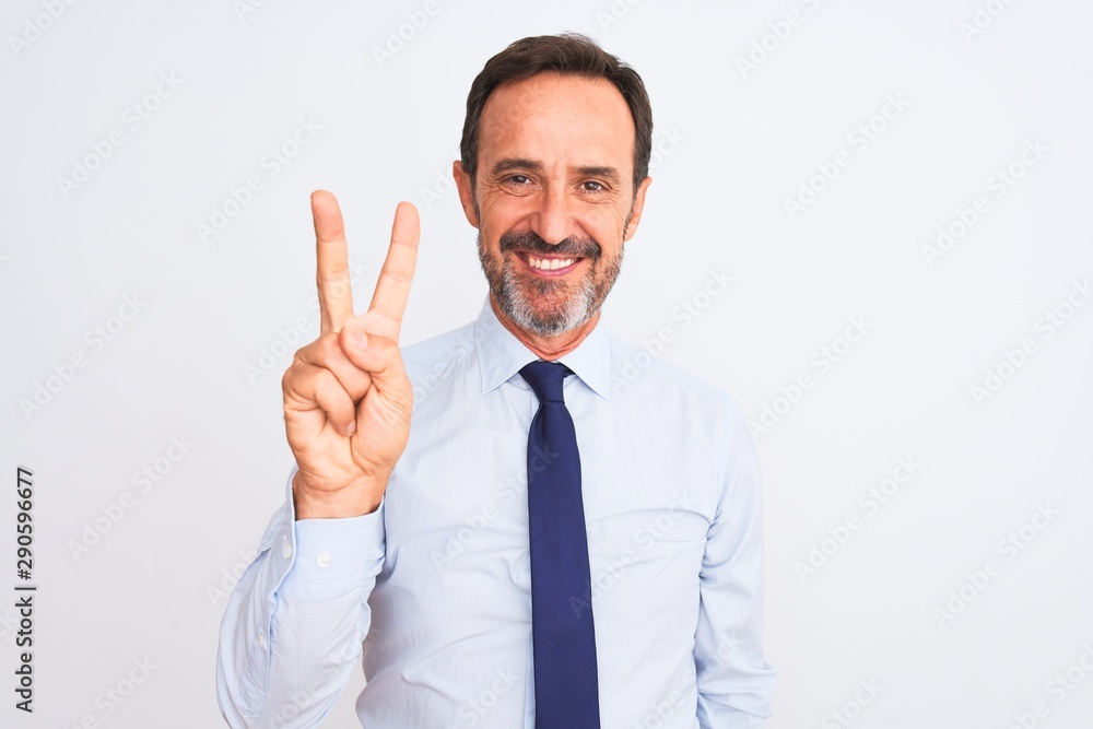 Middle age businessman wearing elegant tie standing over isolated white background showing and pointing up with fingers number two while smiling confident and happy. Middle age businessman wearing elegant tie standing over isolated white background showing and pointing up with fingers number two while smiling confident and happy.