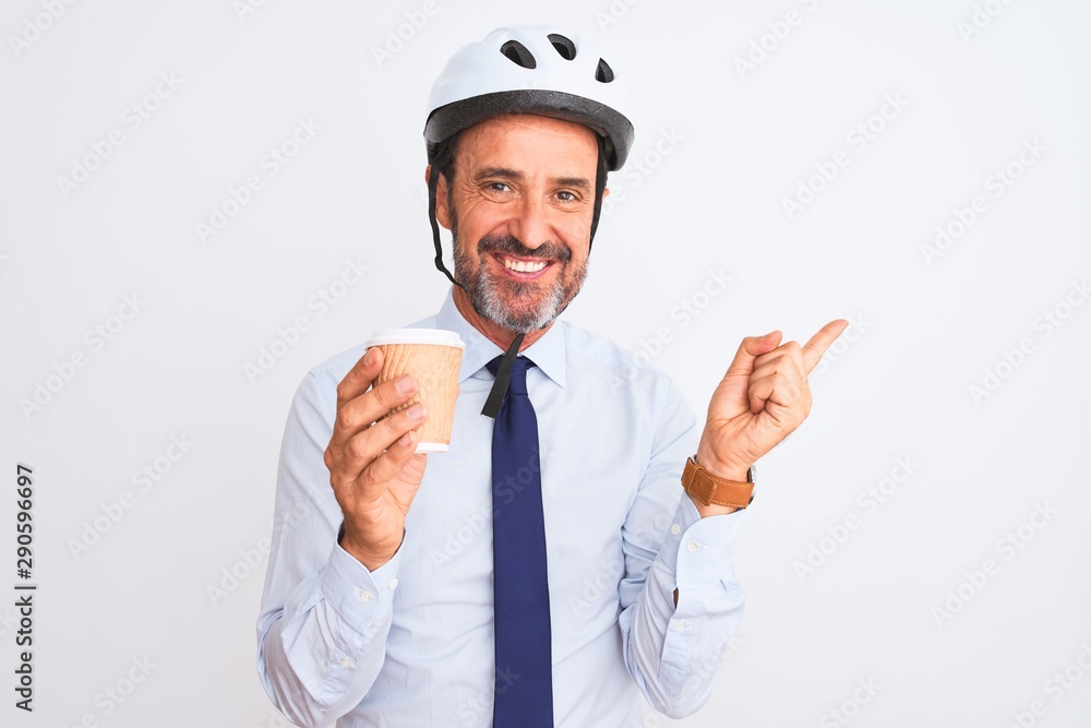 Middle age businessman wearing bike helmet drinking coffee over isolated white background very happy pointing with hand and finger to the side Middle age businessman wearing bike helmet drinking coffee over isolated white background very happy pointing with hand and finger to the side