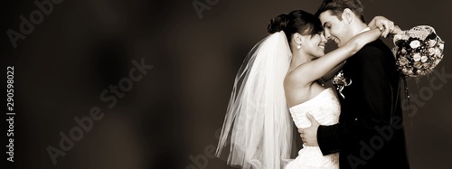 Fotografie Happy just married young couple on black background, vintage