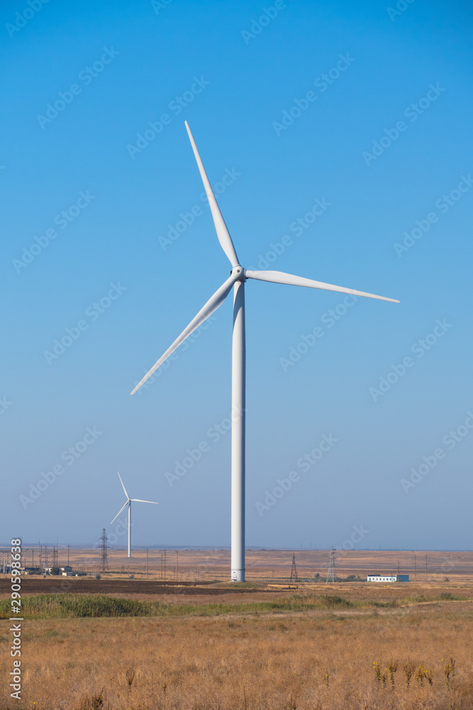 Propellers of windmills, close-up. Spinning wind turbines on blue sky background, close up Propellers of windmills, close-up. Spinning wind turbines on blue sky background, close up