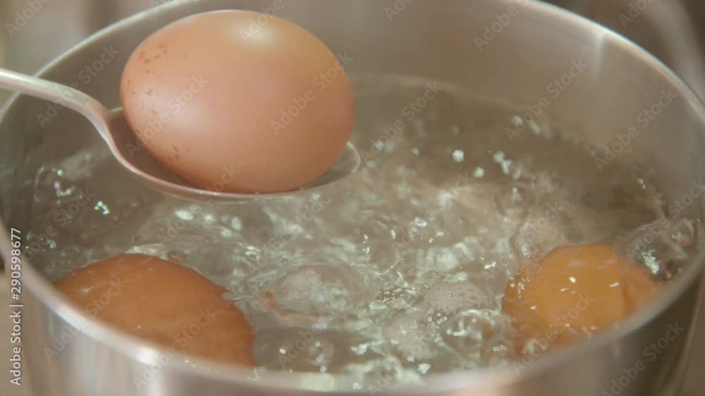 Slow motion shot of brown eggs boiling in a pot, 60 fps Slow motion shot of brown eggs boiling in a pot, 60 fps