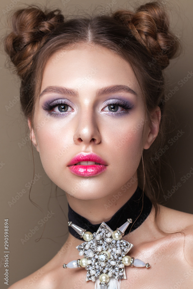 Young beautiful girl with the colorfull make-up, perfect skin, bunches hairstyle Young beautiful girl with the colorfull make-up, perfect skin, bunches hairstyle