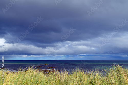 Storm clouds above coast showing grass and sea beyond, taken near Wick in Scottish Highlands (part of North Coast 500 route), lots of space for text. © DMac