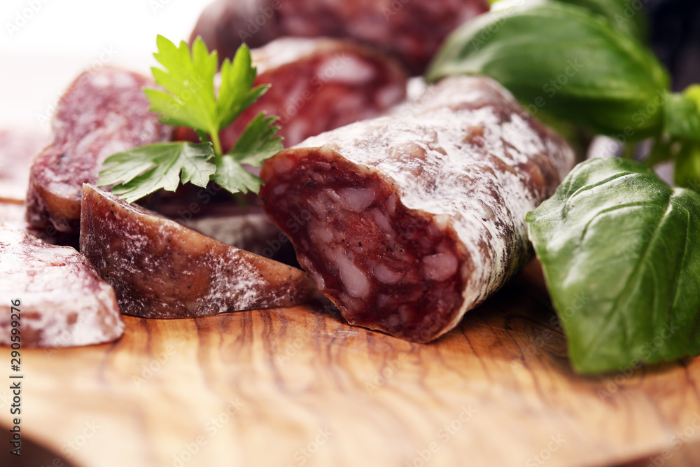 salami cut. thinly sliced salami on a wooden texture on the background. salami cut. thinly sliced salami on a wooden texture on the background.