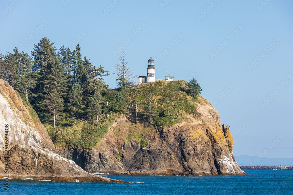 USA, Washington State, Ilwaco, Cape Disappointment State Park. Cape Disappointment Lighthouse on cliff above the Columbia River Bar and Pacific Ocean.