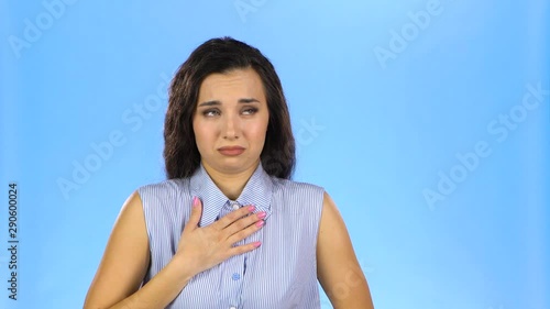 Young woman feeling nauseous touching her chest