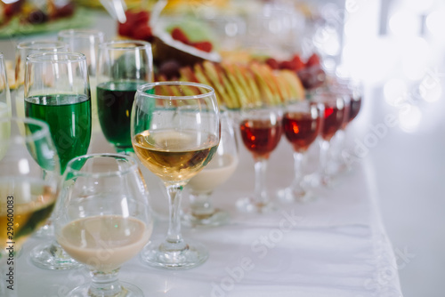 Festive table with cold exotic alcoholic beverages, cocktails and fruits. Celebration or other event