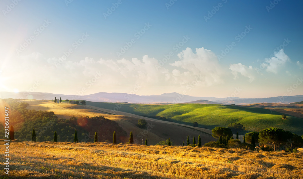Obraz premium sunset over autumn Tuscany countryside landscape; rolling hills and village
