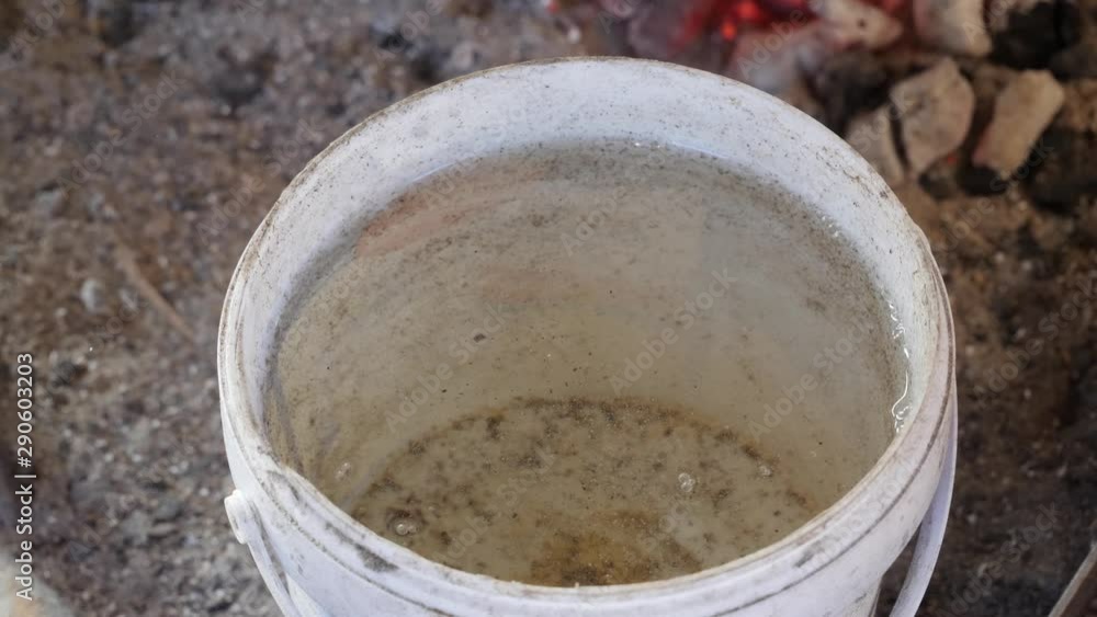Quenching a hot handmade blade in a bucket of water while forging a knife. Quenching a hot handmade blade in a bucket of water while forging a knife.