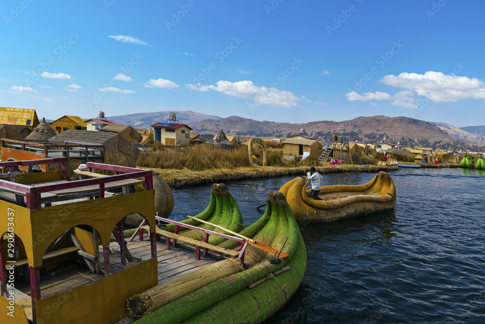 View of Uros floating islands with typical boats, Puno, Peru