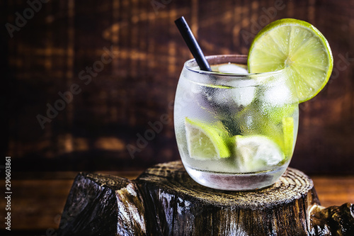 Sticker Fresh summer alcoholic caipirinha on a rustic wooden table, party drinks cocktail background