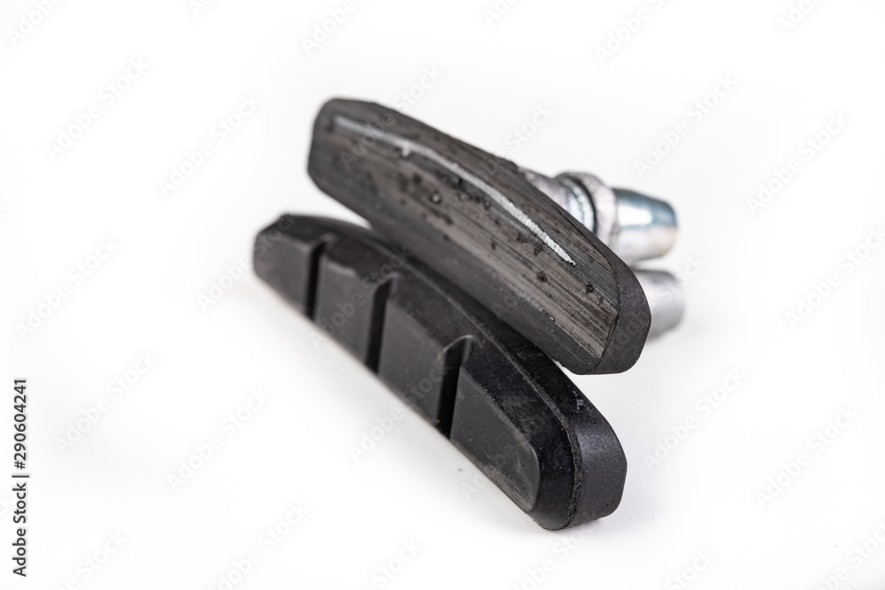 Worn and new brake pads for the bicycle. Replacement and service of bicycle parts in the workshop. Worn and new brake pads for the bicycle. Replacement and service of bicycle parts in the workshop.