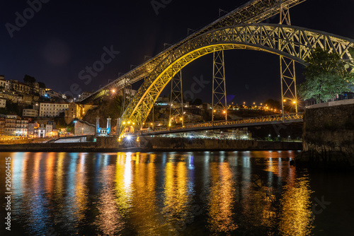Night illuminated metal arch bridge of Ponte Luis I from the banks of the river Douro © steheap