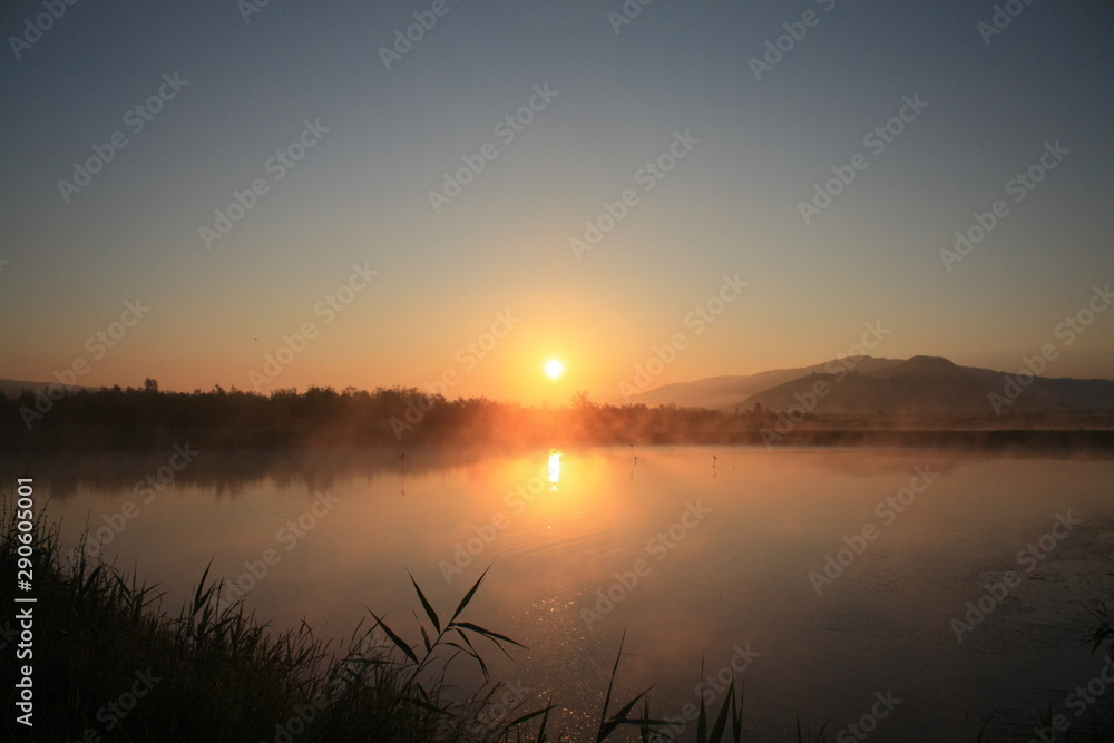 sunrise with fog on the lake