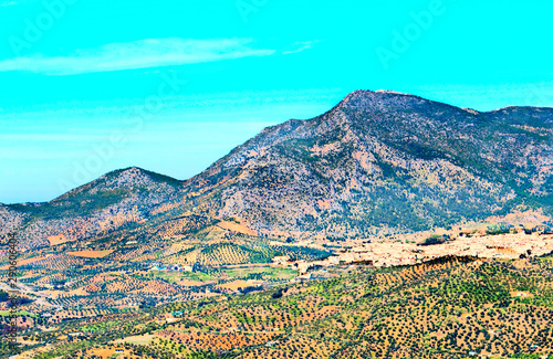 Aerial view of the Spanish city of Zahara de la Sierra in the south of Spain in a sunny day. It´s surrounded by mountains.
