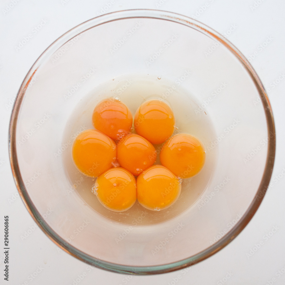 Seven eggs cracked in a glass bowl Seven eggs cracked in a glass bowl