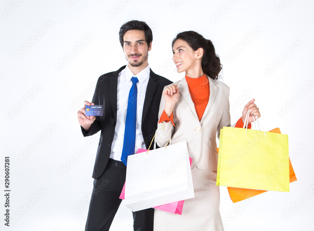 Business people, couples, men, holding credit cards and girlfriends carrying shopping bags colorful are happy to shopping together.Financial business and lifestyle concept. Business people, couples, men, holding credit cards and girlfriends carrying shopping bags colorful are happy to shopping together.Financial business and lifestyle concept.