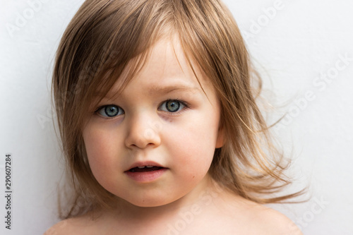 Beautiful blue-eyed toddler baby girl portrait closeup isolated on white