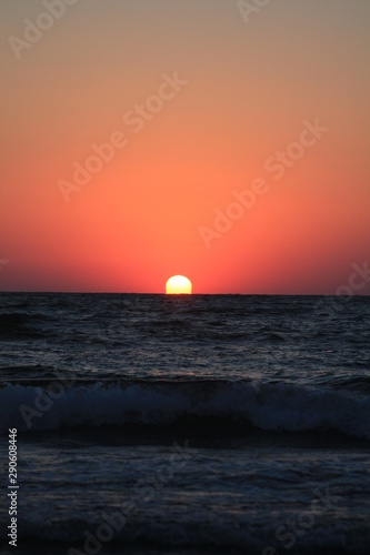 Fototapeta Naklejka Na Ścianę i Meble -  a sunrise at the seashore in red colors