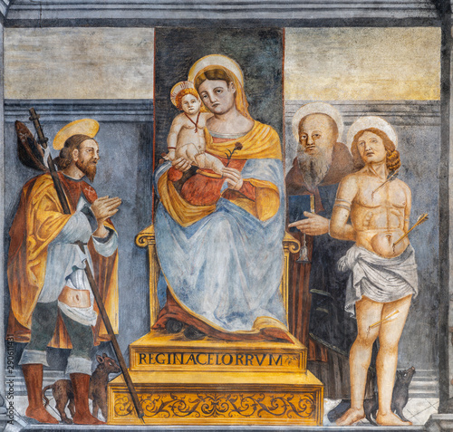 LIMONE SUL GARDA, ITALY - MAY 9, 2015: The freso of Madonna with the saints Roch, Sebastian and probably Benedict in the church San Rocco.