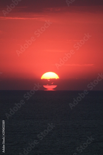 Fototapeta Naklejka Na Ścianę i Meble -  the sun rising from the water of the sea