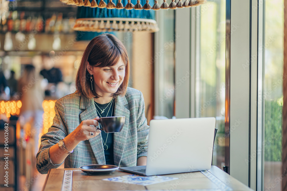 Young woman in blazer with laptop in the cafe near the window. Professions  is a blogger, freelancer and writer. Freelancer working in coffee shop.  Learning online.. Stock Photo | Adobe Stock