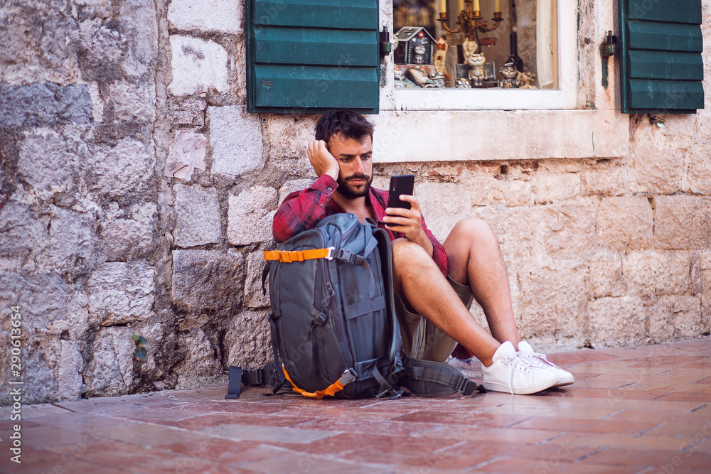 Tourist man using phone and waiting someone