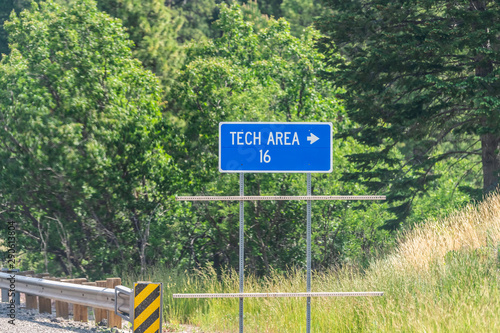 Los Alamos, USA Road to Laboratory in New Mexico on highway street with text of blue tech area sign photo