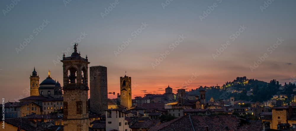 Bergamo at sunset in the old city with towers and bell tower,