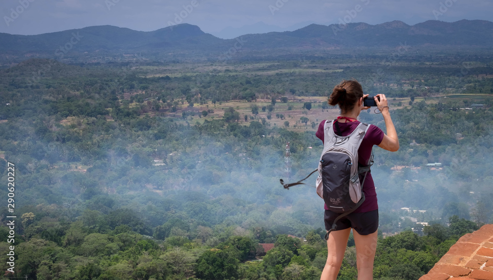 Unsprcific woman is taking at the top of Sigiriya Rock fortress, Sri Lanka. Unsprcific woman is taking at the top of Sigiriya Rock fortress, Sri Lanka.