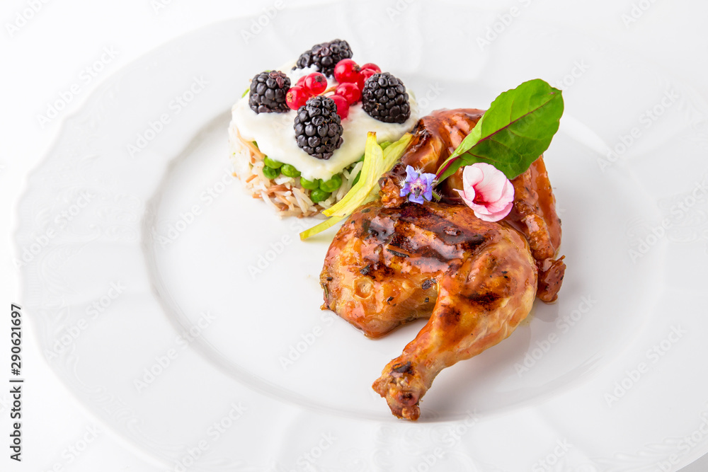 Grilled quail in a sauce with vegetables and berry confiture. Banquet festive dishes. Fine dining restaurant menu. White background. Grilled quail in a sauce with vegetables and berry confiture. Banquet festive dishes. Fine dining restaurant menu. White background.