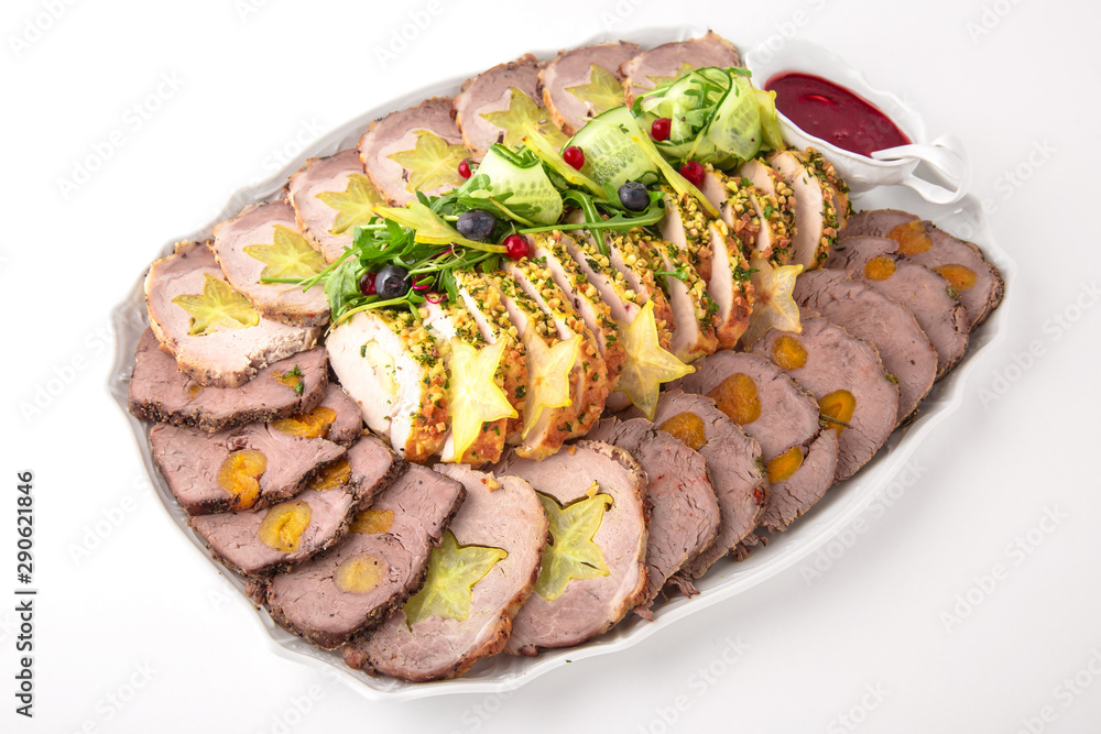 Roast pork or lamb with grilled vegetables and exotic fruits. Banquet festive dishes. Fine dining restaurant menu. White background. Roast pork or lamb with grilled vegetables and exotic fruits. Banquet festive dishes. Fine dining restaurant menu. White background.