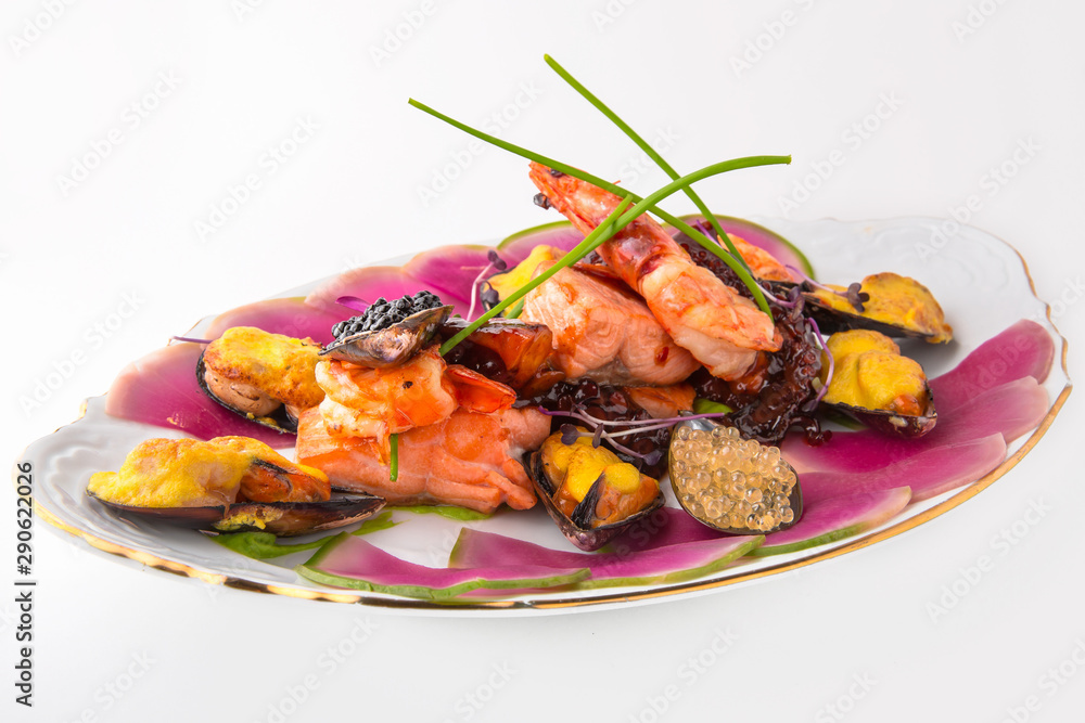 Luxurious seafood platter: king prawns, baked mussels with cheese, salmon, octopus and caviar. Banquet festive dishes. Fine dining restaurant menu. White background. Luxurious seafood platter: king prawns, baked mussels with cheese, salmon, octopus and caviar. Banquet festive dishes. Fine dining restaurant menu. White background.