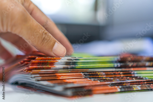 Business Documents concept : Businessman hands working in Stacks Brochures paper files for checking document achieves reports on busy work desk office